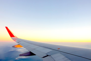 Morning cloudy sunrise with Wing of an airplane. picture for add text message or frame website. Traveling concept