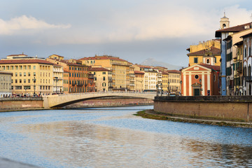View on embankment of Arno river and bridge Ponte Di Mezzo. Pisa, Italy