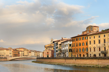 Fototapeta na wymiar View on embankment of Arno river and bridge Ponte Di Mezzo. Pisa, Italy