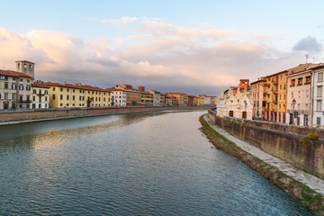 View on embankment of Arno river with Church of Santa Maria de la Spina at sunset. Pisa, Italy