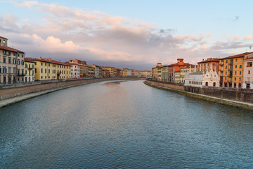 View on embankment of Arno river with Church of Santa Maria de la Spina at sunset. Pisa, Italy