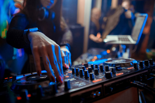 DJ sound equipment at nightclubs and music festivals, EDM, future house music and so on. Parties concept, sound technique. DJ playing on the best, famous CD players.