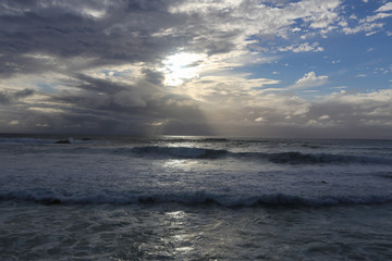 Sunset and wave action at high tide on the California coast between winter storms
