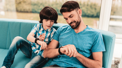 Little Boy with Father Wacthing on Hand Watches.