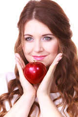 Woman holding apple fruit close to face