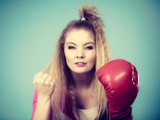 Cute girl in red gloves playing sports boxing
