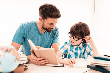 Little Boy in Glasses Doing Homework with Father.