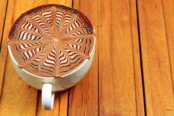 Hot coffee latte on wooden background for background decoration.