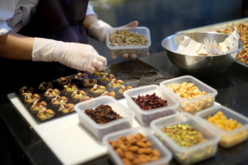 Dessert chef preparing milk chocolate and almond appetizer