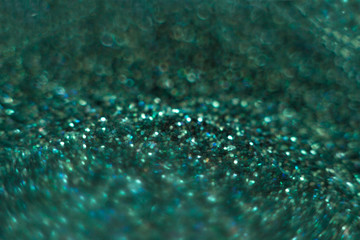 Defocused explosive spot of turquoise light powder Christmas and Valentine's Day to copy space.