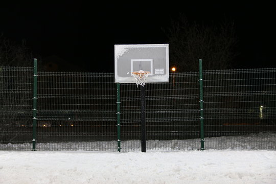 basketball court after blizzard arena whole snow. Basketball hoop after snowstorm filled with snow. winter basketball. 