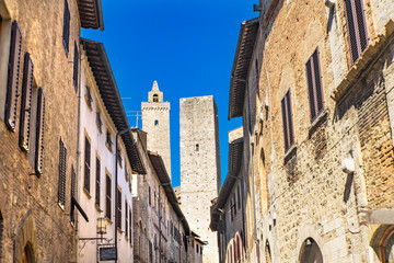 Fototapeta na wymiar Medieval Street Stone Cuganensi Towers San Gimignano Tuscany Italy
