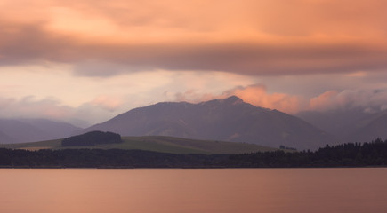 Long Exposure Shot of Liptovska Mara Lake, Low Tatras Mountains and Cloudy Sky at Sunset.