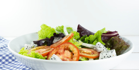 Healthy salad diet food concept, props decoration kiwi, tomatoes, apple, avocado, Red chilli, Green pepper, lemon and measuring tape.