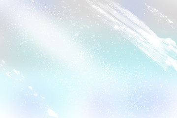 Obraz premium Winter shiny snowflakes blurred background in light blue color. Blurry Christmas holiday background with snow flakes, frost pattern, soft flares of light. Copy space