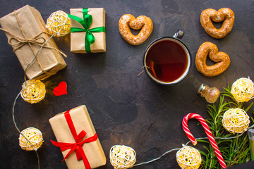 Fototapeta premium tea, cup, gingerbread, caramel, gifts for the holiday. Brewed tea bag, cup of tea and a festive atmosphere. top view. copy space