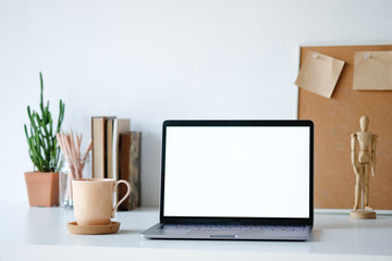 Workplace mockup concept. Selective focus Mockup home decor laptop computer and office object with copy space for products display montage.Mockup desktop