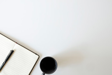 Copy space top view office desk coffee, pen and notebook.