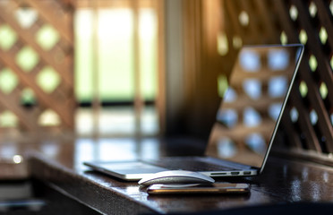 Notebooks and smart phone ready to use placed in the natural atmosphere. Business and Technology Concepts.