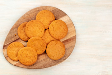 Ginger biscuits on a wooden tray, shot from the top with a place for text