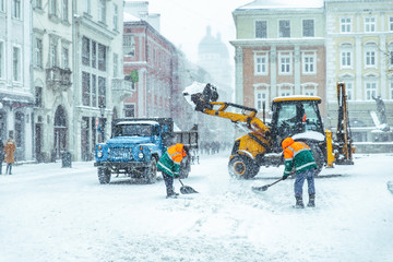 people cleaning city streets after snowstorm