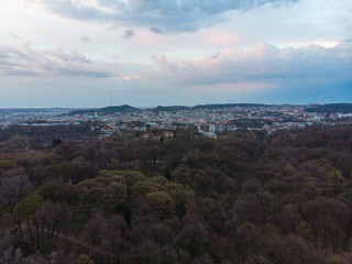 panoramic view of city park with city on background over sunset with dramatic sky