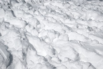 Beautiful pure white snow on the ground outdoor. Traces and footsteps, natural texture pattern. Snowy weather condition. Winter concept.
