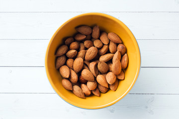Almonds in a bowl. Selective focus. Close up