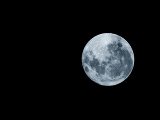 Full moon / The Moon is an astronomical body that orbits planet Earth and is Earth's only permanent natural satellite. It is the fifth-largest natural satellite in the Solar System