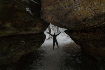 Man silhouette at the entrance to cave or tunnel