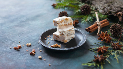 Happy Christmas. The concept of postcards, Christmas greetings, Christmas articles. Christmas sweets, cinnamon, tree branches, anise, cones. Close up. Selective focus.