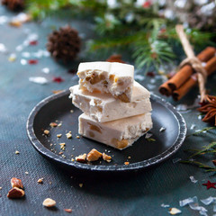 Happy Christmas. The concept of postcards, Christmas greetings, Christmas articles. Christmas sweets, cinnamon, tree branches, anise, cones. Close up. Selective focus.