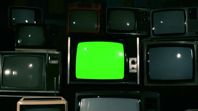 80S Tvs With Green Screen. Dolly Shot. Blue Steel Tone.You can replace green screen with the footage or picture you want with &ldquo;Keying&rdquo; effect in AE  (check out tutorials on YouTube).