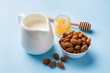 Almonds in a bowl and milk on the table. Selective focus. Copy space.