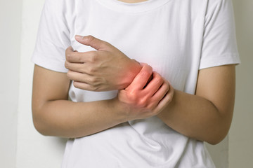 Female holding hand to spot of wrist pain.