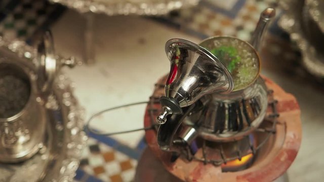 A Moroccan woman prepares mint tea in her home in Fez, Morocco