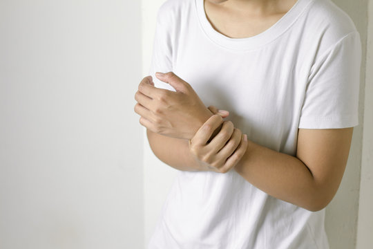 Female holding hand to spot of wrist pain.