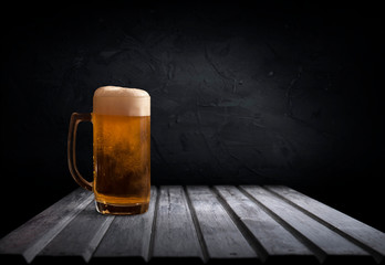 mug of beer on dark background drink