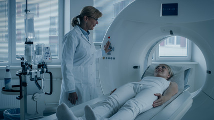 In Medical Laboratory Female Radiologist Controls MRI or CT or PET Scan with Female Patient...