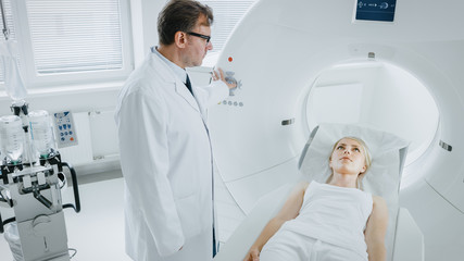 In Medical Laboratory Male Radiologist Controls MRI or CT or PET Scan with Female Patient...