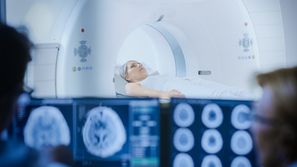 In Medical Laboratory Patient Undergoes MRI or CT Scan Process under Supervision of Doctor and Radiologist in Control Room, They Watche Procedure and Monitors Brain Activity Results. - obrazy, fototapety, plakaty