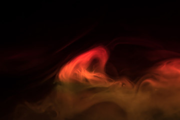 orange smoke (evaporation) on a black background
