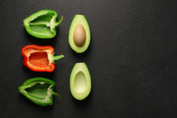Healthy food clean eating selection on gray background. Green and red bell pepper, avocado. Top view