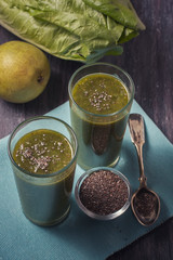 green smoothie with fruits and vegetables on black background