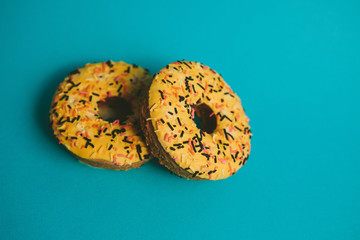 Yellow doughnuts on blue background with copy space