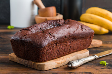Chocolate banana bread and fresh fruits on wooden rustic table