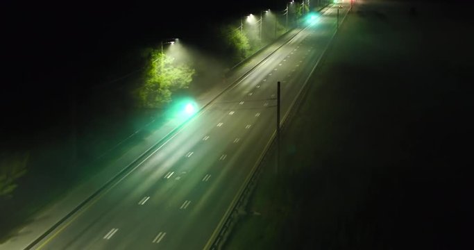 Green traffic signals on reverse stretch of road, top view