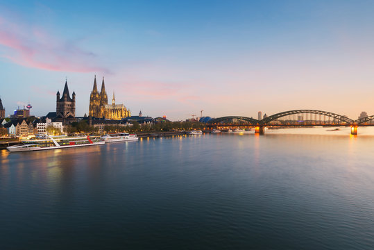 Image of Cologne with Cologne Cathedral with Rhine river and Hohenzollern  bridge during twilight blue hour in Germany.