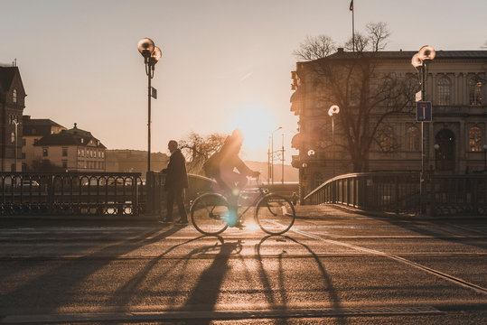 Man bicycling at sunset in Stockholm, Sweden