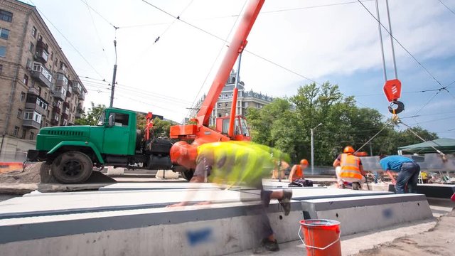 Installing concrete plates by crane at road construction site timelapse hyperlapse.
